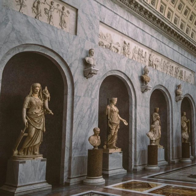 a bunch of statues that are inside of a building, a marble sculpture, by Carlo Martini, pexels contest winner, displayed on the walls, roman style, petite, indoor picture