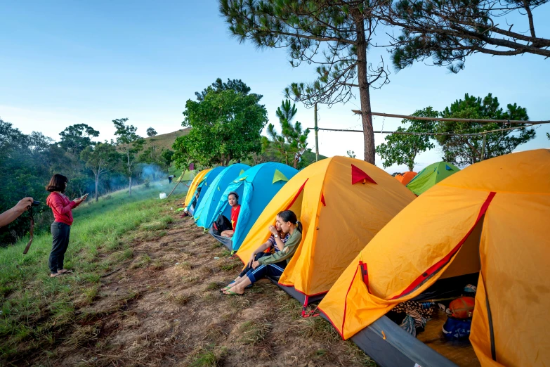 a group of people standing around a group of tents, by Bernardino Mei, pexels contest winner, arrendajo in avila pinewood, avatar image, square, campy and colorful