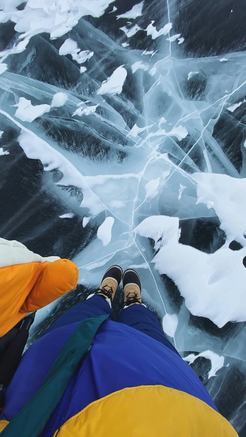 a couple of people standing on top of a frozen lake, by Jessie Algie, pexels contest winner, land art, detailed shot legs-up, thumbnail, glaciers, trending on vsco