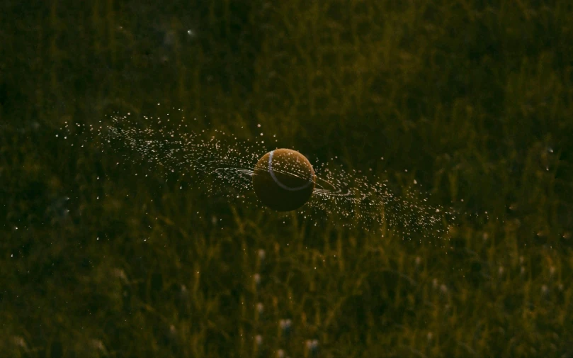 a tennis ball is sprinkled with water, by Attila Meszlenyi, unsplash contest winner, digital art, golden hour firefly wisps, samorost, soccer, ignant