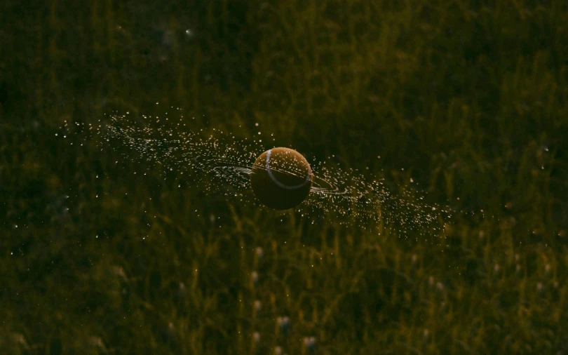 a tennis ball is sprinkled with water, by Attila Meszlenyi, unsplash contest winner, digital art, golden hour firefly wisps, samorost, soccer, ignant