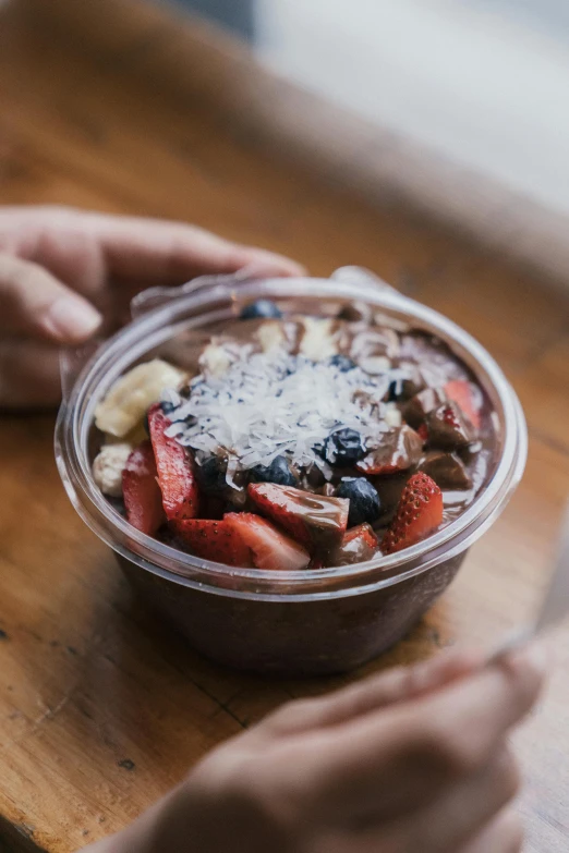 a close up of a person eating a bowl of food, fully chocolate, fresh fruit, ko-fi, grey