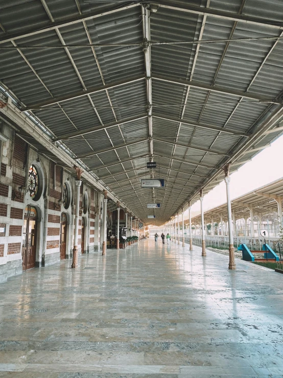 an empty railway station that is covered by metal sheet