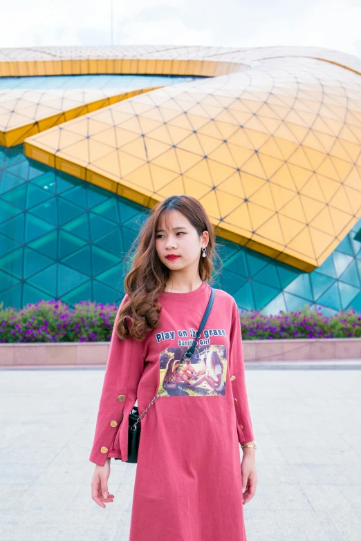 a woman standing in front of a building, a picture, inspired by Cheng Jiasui, pexels contest winner, long sleeves, maroon red, ( ( ( colorful ) ) ), cute casual streetwear