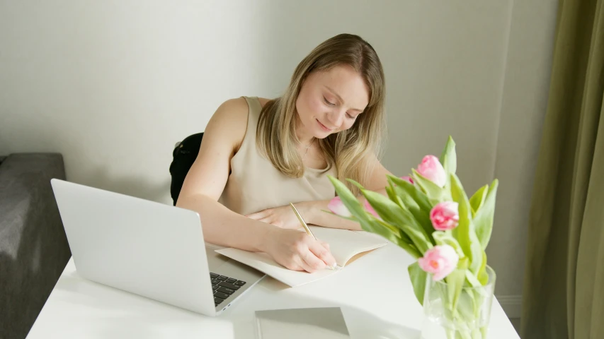 a woman sitting at a table with a laptop and flowers, white sketchbook style, writing a letter, a girl with blonde hair, plain background