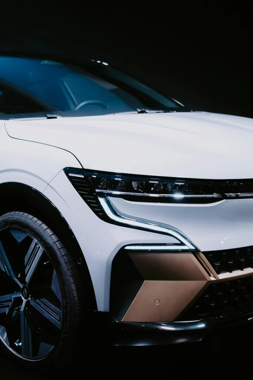 a white suv is seen at a car show