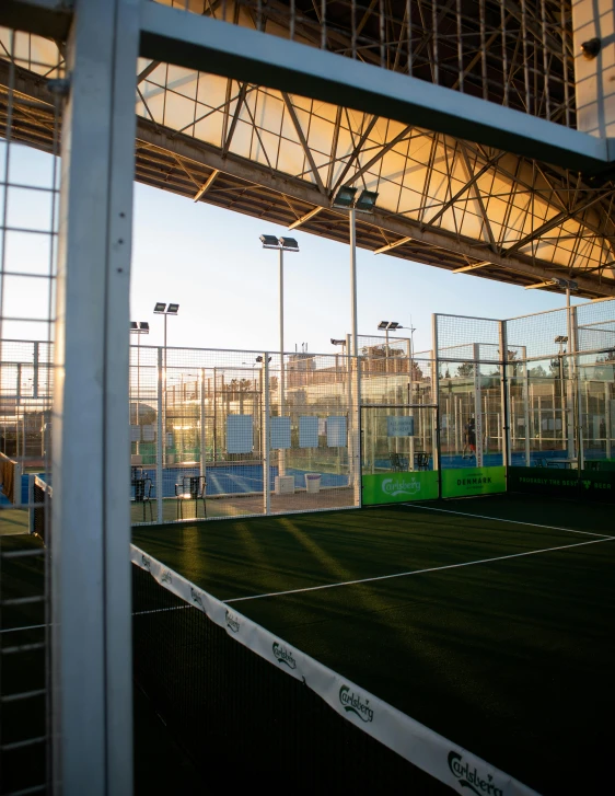 an outdoor tennis court in front of a city skyline