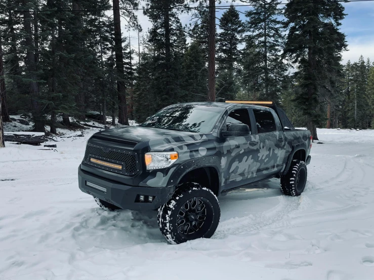a truck that is sitting in the snow, featured on reddit, tundra, wearing camo, 2 0 % pearlescent detailing, gunmetal grey