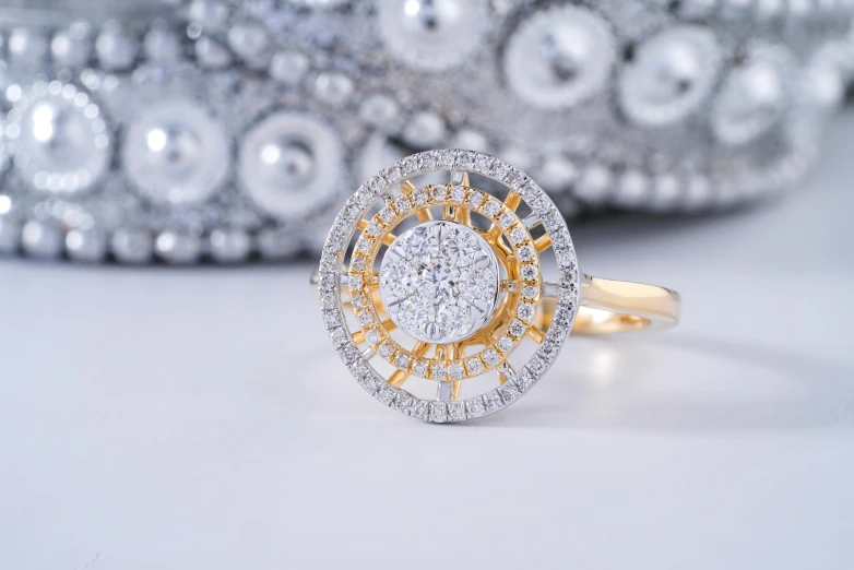 a diamond ring sitting on top of a table, a stipple, gold ornaments, product shoot, fan favorite, round design