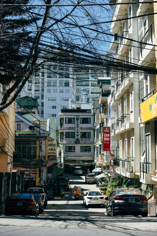 a city street lined with tall white buildings