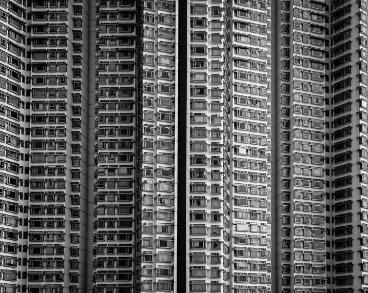 a black and white photo of a tall building, a black and white photo, inspired by Thomas Struth, pexels contest winner, brutalism, kowloon, dystopian city apartment, many windows, super detailed