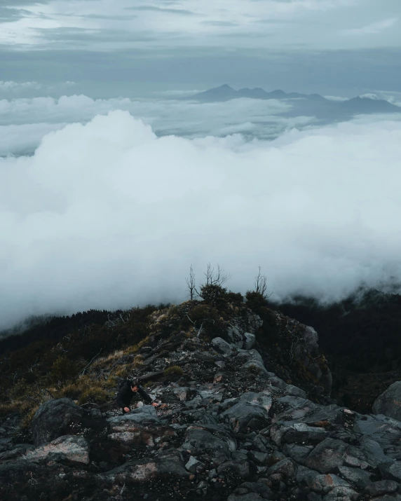 the view is over a cloud covered mountain peak