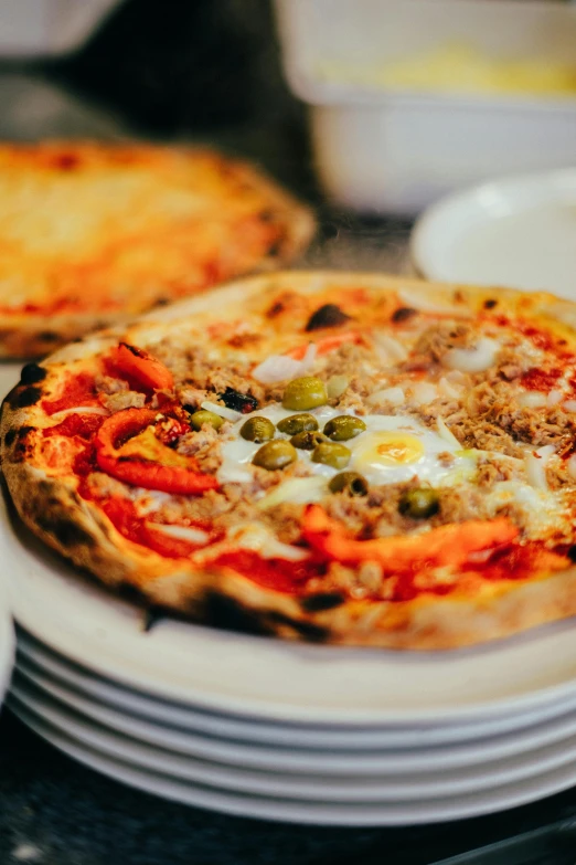 a couple of pizzas sitting on top of white plates, saturno buttò, vibrant light, hot food, smug