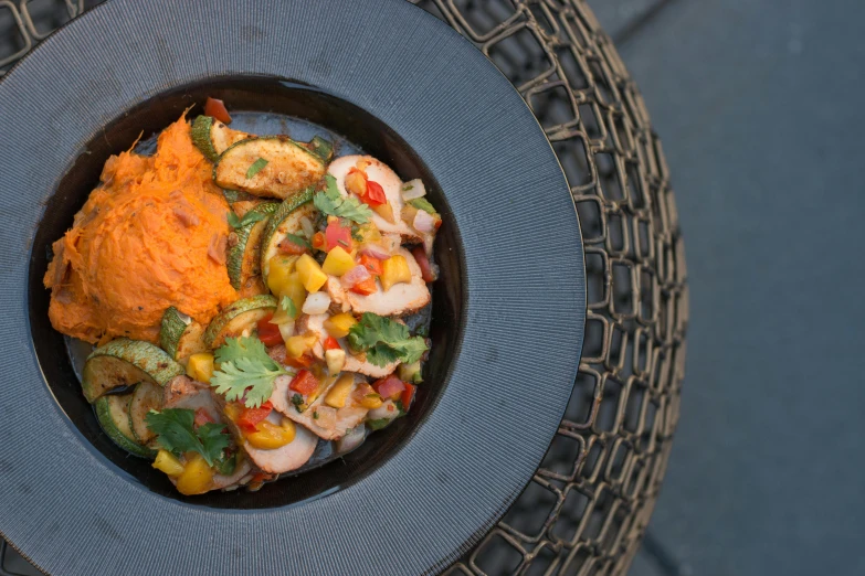 a close up of a plate of food on a table, by Carey Morris, pichacu cooks a squid, ratatouille style, bowl, summer night