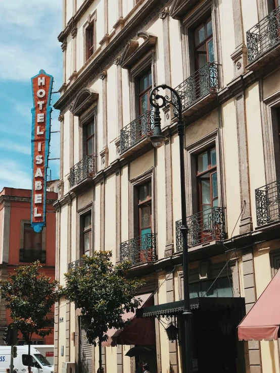 buildings with balconies and a clock tower in the background