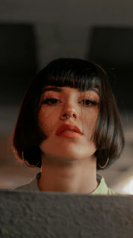 a close up of a person looking at something, an album cover, inspired by Elsa Bleda, trending on pexels, hyperrealism, black bob cut hair, young angry woman, whitebangs, high quality photo