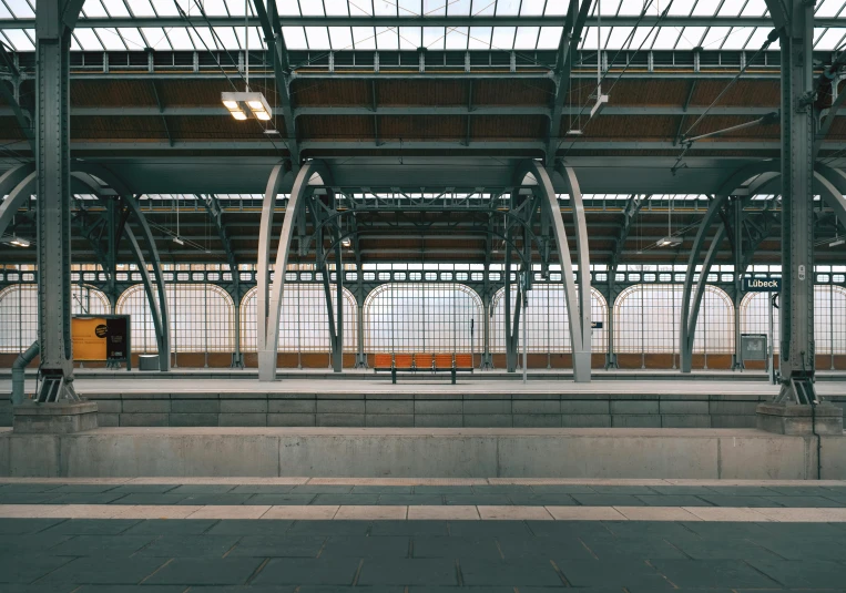 a train sitting inside of a train station, inspired by Thomas Struth, unsplash contest winner, hyperrealism, steel archways, clemens ascher, benches, seen from outside