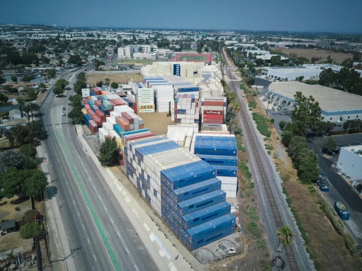 an aerial view of a city with lots of shipping containers, an album cover, by Ryan Pancoast, reddit, photorealism, 1600 south azusa avenue, research complex, exterior wide shot, photo taken on a nikon