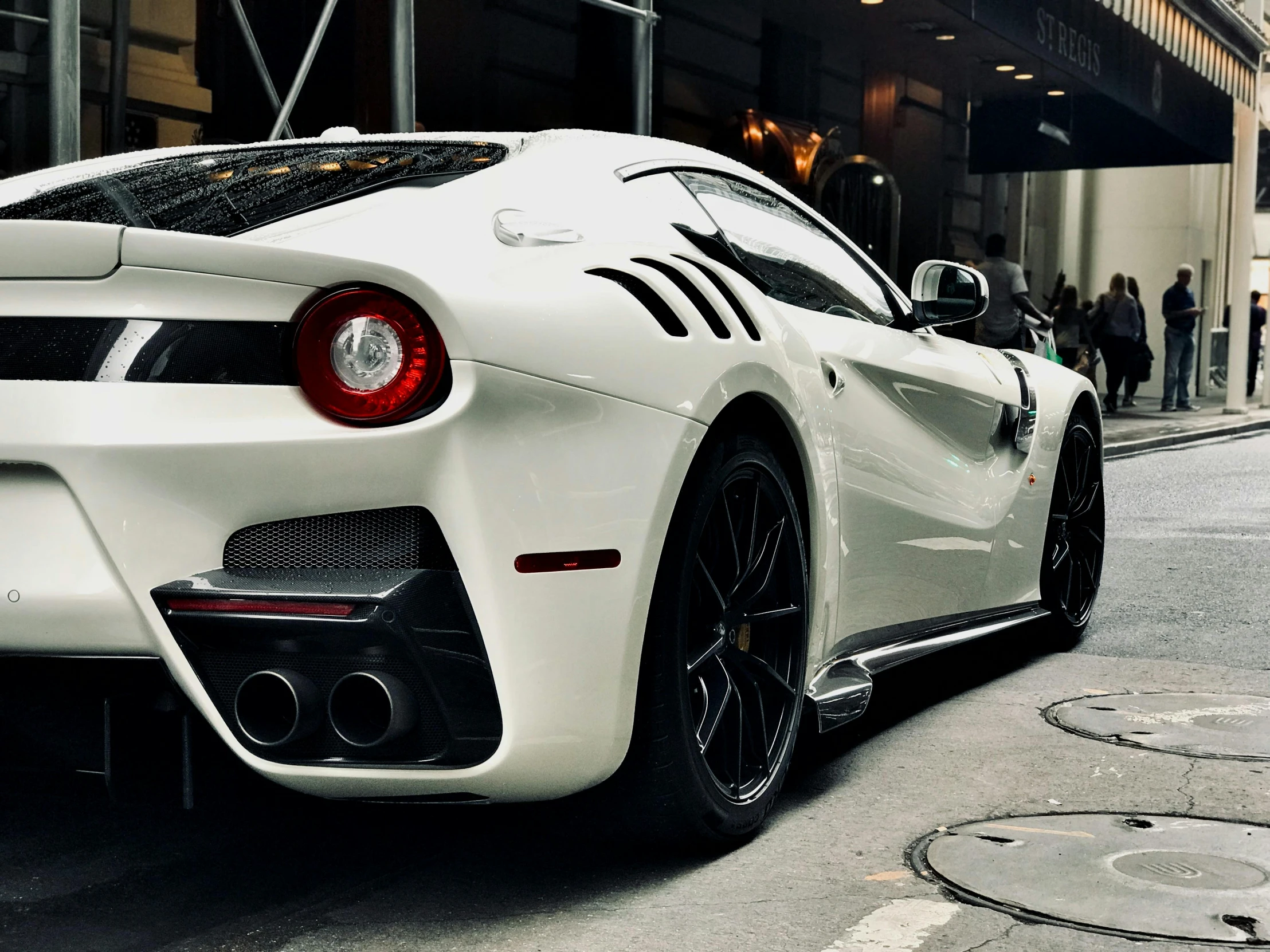 the white sports car is parked near a building