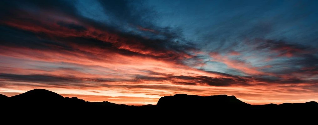 the sunset is casting pink and purple clouds