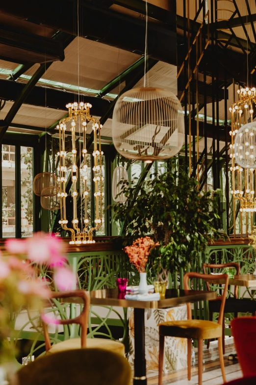 an elaborately set up restaurant with chandelier and chairs