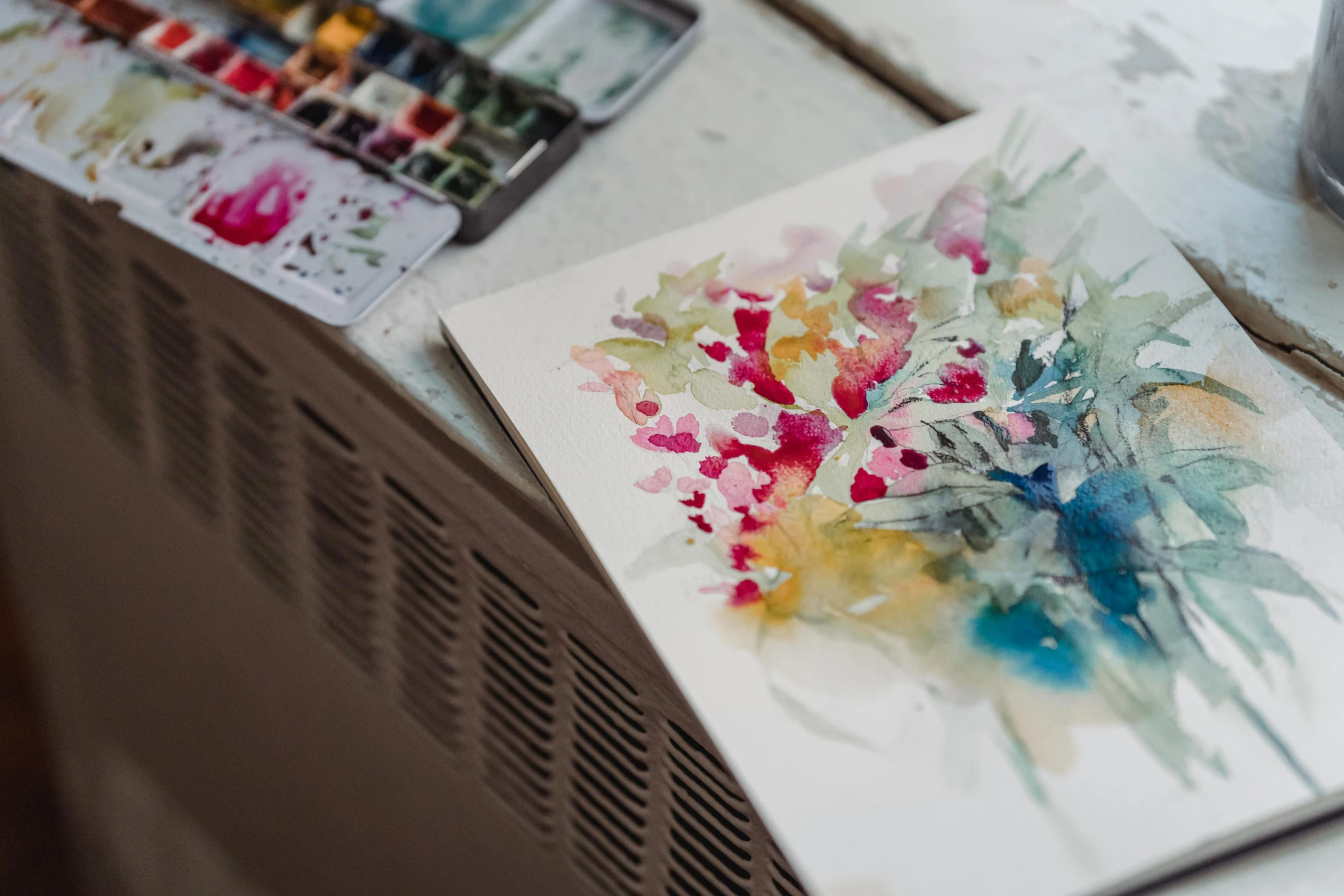 a painting of a bunch of flowers on a table, a watercolor painting, inspired by Carne Griffiths, pexels contest winner, stands at her easel, close - up photograph, amanda lilleston, illustrative and abstract