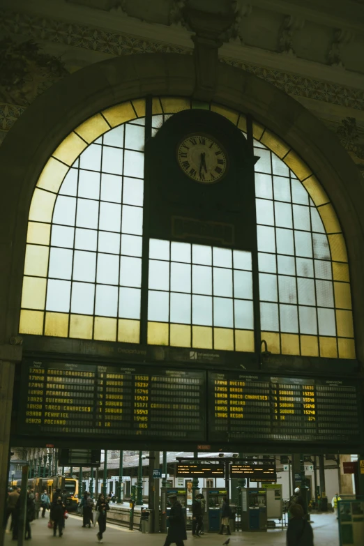 a clock on a wall next to windows