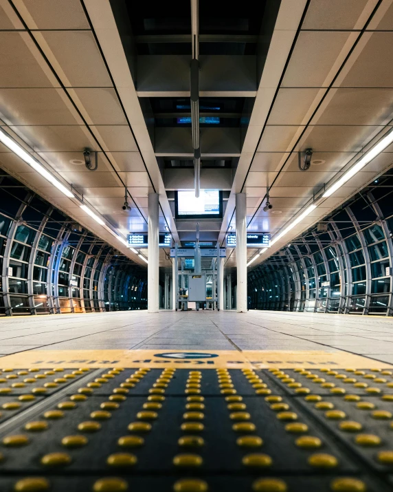 a train station with lots of yellow dots on the floor, unsplash contest winner, jr sc maglev, ramps, empty floor, cupertino