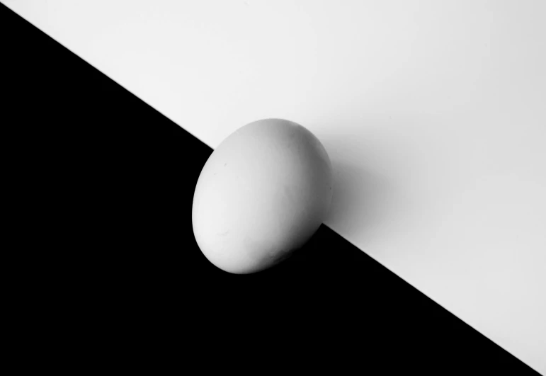 a white egg sitting on top of a black and white surface, matt rhodes, an abstract, sergey vasnev, shadow gradient