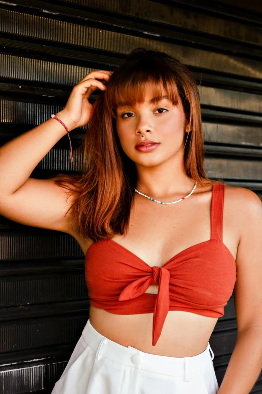 a woman in a red top and white skirt, by Robbie Trevino, instagram, wearing bra, closeup portrait shot, manila, coral brown hair