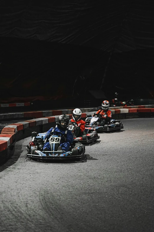 people are racing motorcycles around the track on roller blades