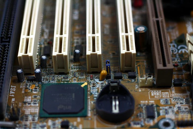 a close up of a computer mother board, by Carey Morris, in front of a computer, where a large, mechanised, 90s photo