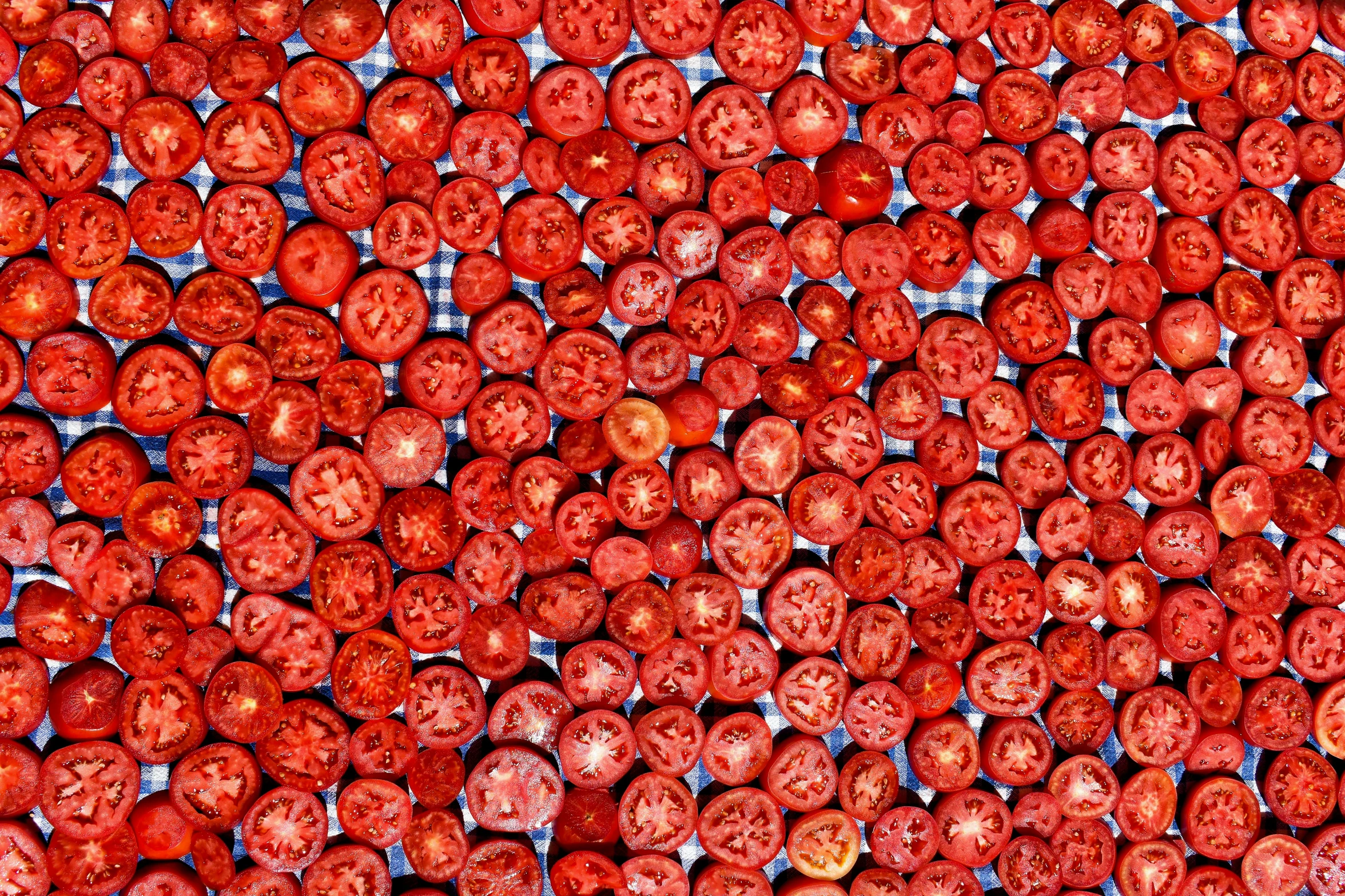 a pile of tomatoes sitting on top of a table, by Jon Coffelt, flickr, pointillism, intricate hyperdetail macrophoto, 64x64, detailed glowing red implants, aerochrome eyes