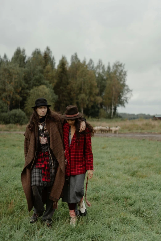 a couple of people that are standing in the grass, tartan garment, two models in the frame, in style of heikala, wearing dirty travelling clothes