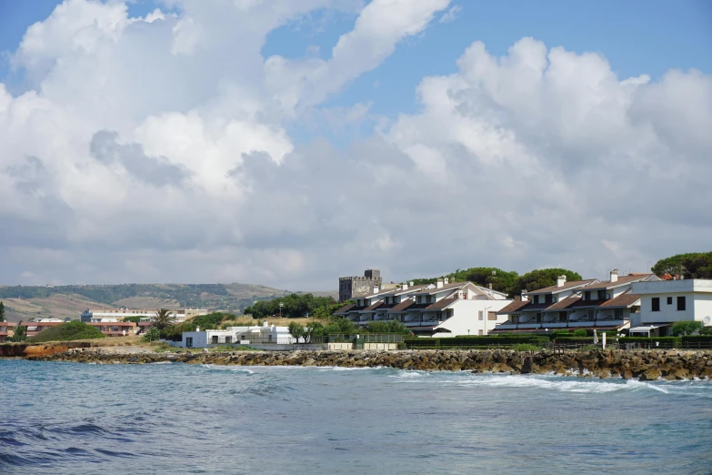 the houses are by the sea under cloudy skies