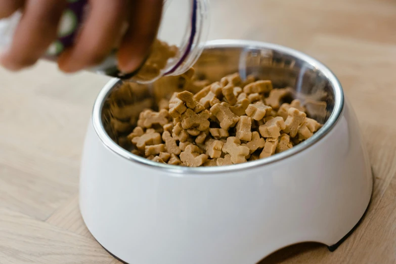 the person is mixing food in the bowl