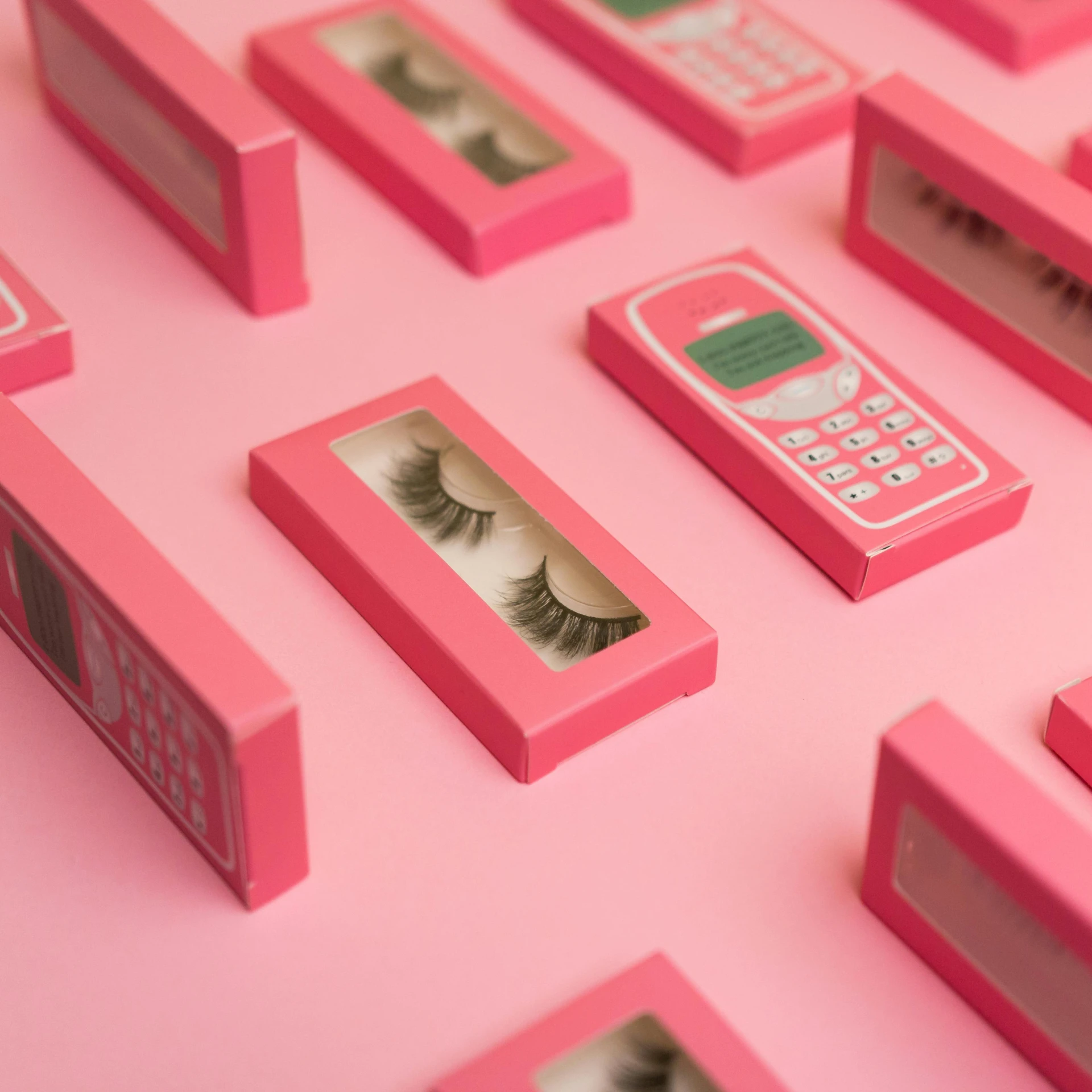 a close up of a box of eyelashes on a pink surface, trending on pexels, pop art, dials, phone photo, 3 d product render, in a row