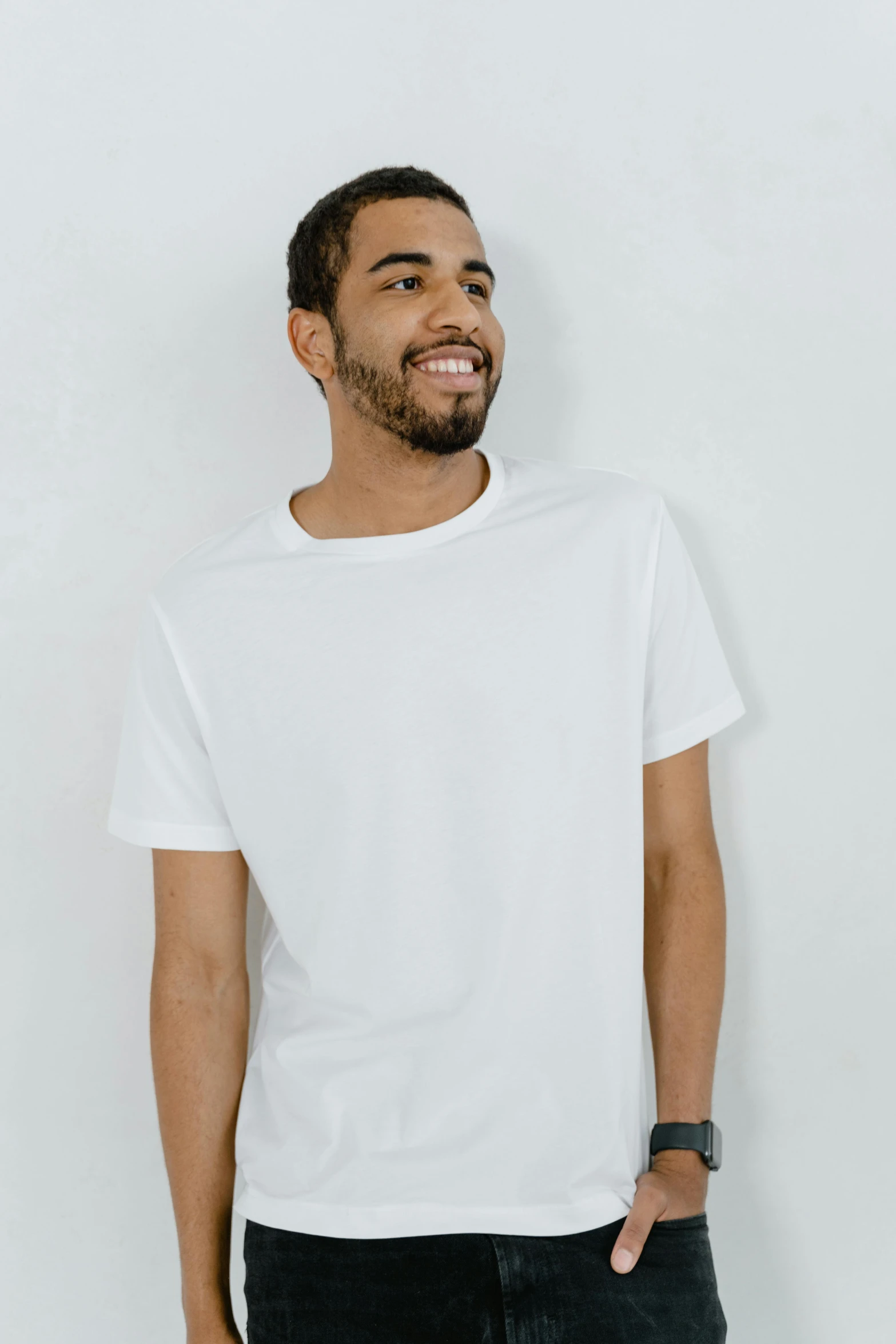 a man standing in front of a white wall, dressed in a white t shirt, looking happy, highly upvoted, official product image