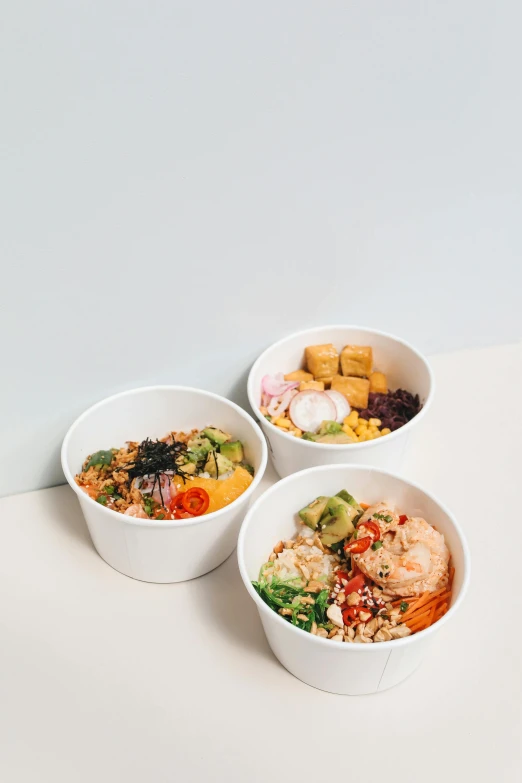 three bowls of food sitting on a table, product image, seattle, with a white background, jakarta