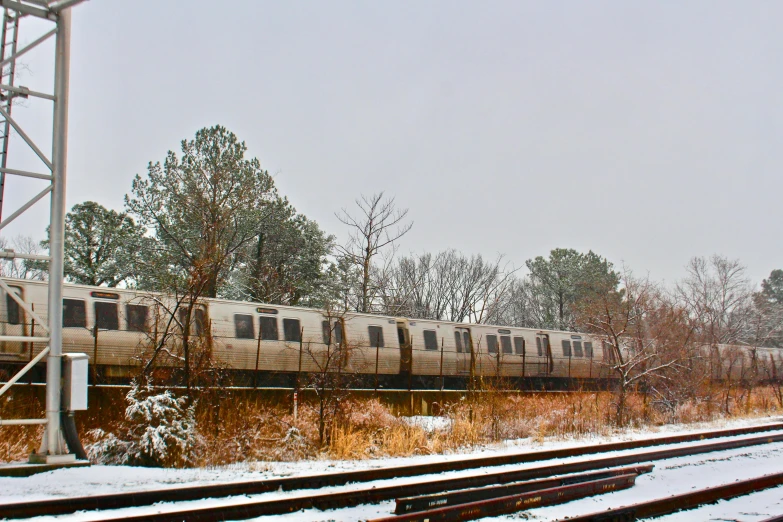 a large long train on a steel track, by Washington Allston, unsplash, graffiti, pale as the first snow of winter, 2000s photo, getty images, panoramic