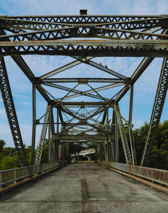 a close up of a bridge with a sky background, an album cover, by Carey Morris, unsplash, old american midwest, 2 5 6 x 2 5 6 pixels, street view, rusty metal towers