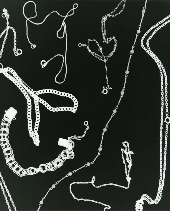 a black and white photo of a bunch of necklaces, by Carol Sutton, 1 9 8 5 photograph, x-ray photography, 1930 photo, ((chains))