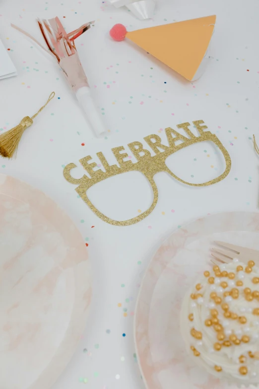 a birthday cake sitting on top of a white table, wearing gold glasses, cardstock, curated collection, specks