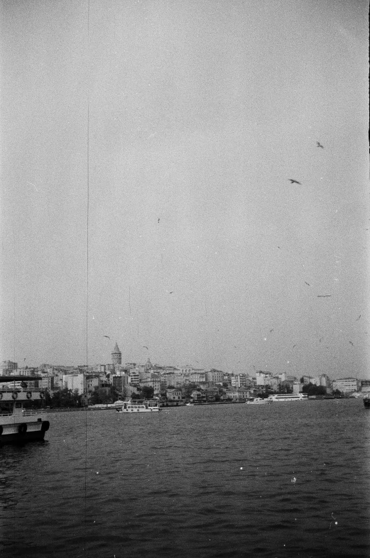 a black and white photo of a body of water, istanbul, 6 june 1944, 1920, photo taken from a boat