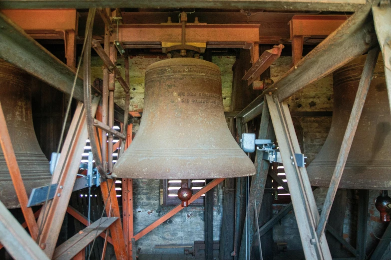 a large bell hanging from the ceiling of a building, madgwick, large scale photo, brown, liam