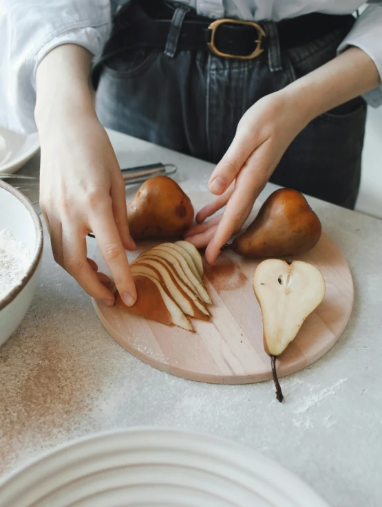 a person cutting a pear on a cutting board, inspired by Sarah Lucas, japanese collection product, fully decorated, aesthetically pleasing, product introduction photo