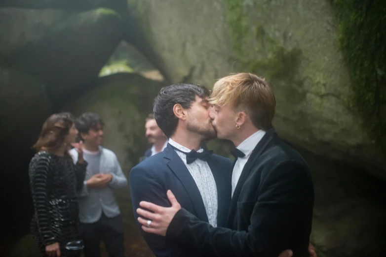 a couple of men standing next to each other, kissing, well decorated, celebrating, killian eng