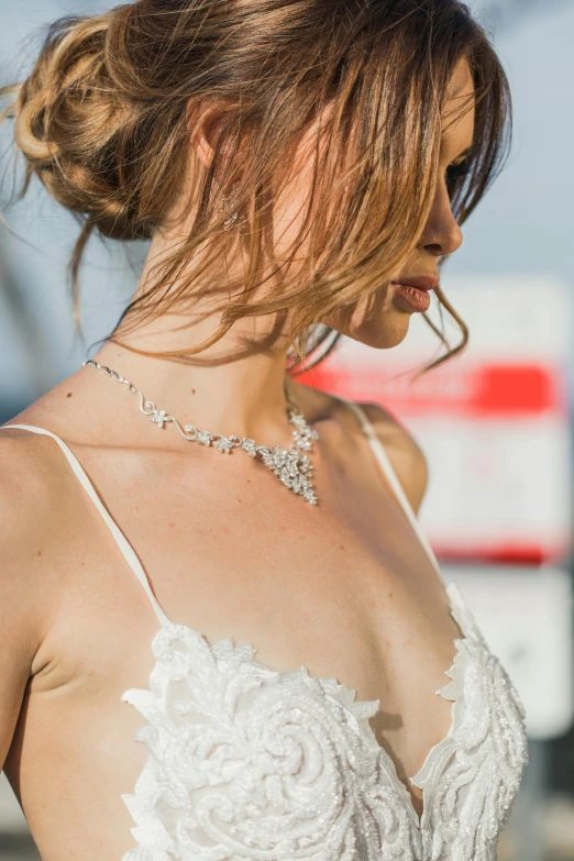 a close up of a woman wearing a wedding dress, a photo, inspired by Nicolette Macnamara, silver necklace, at the waterside, bralette, vivid