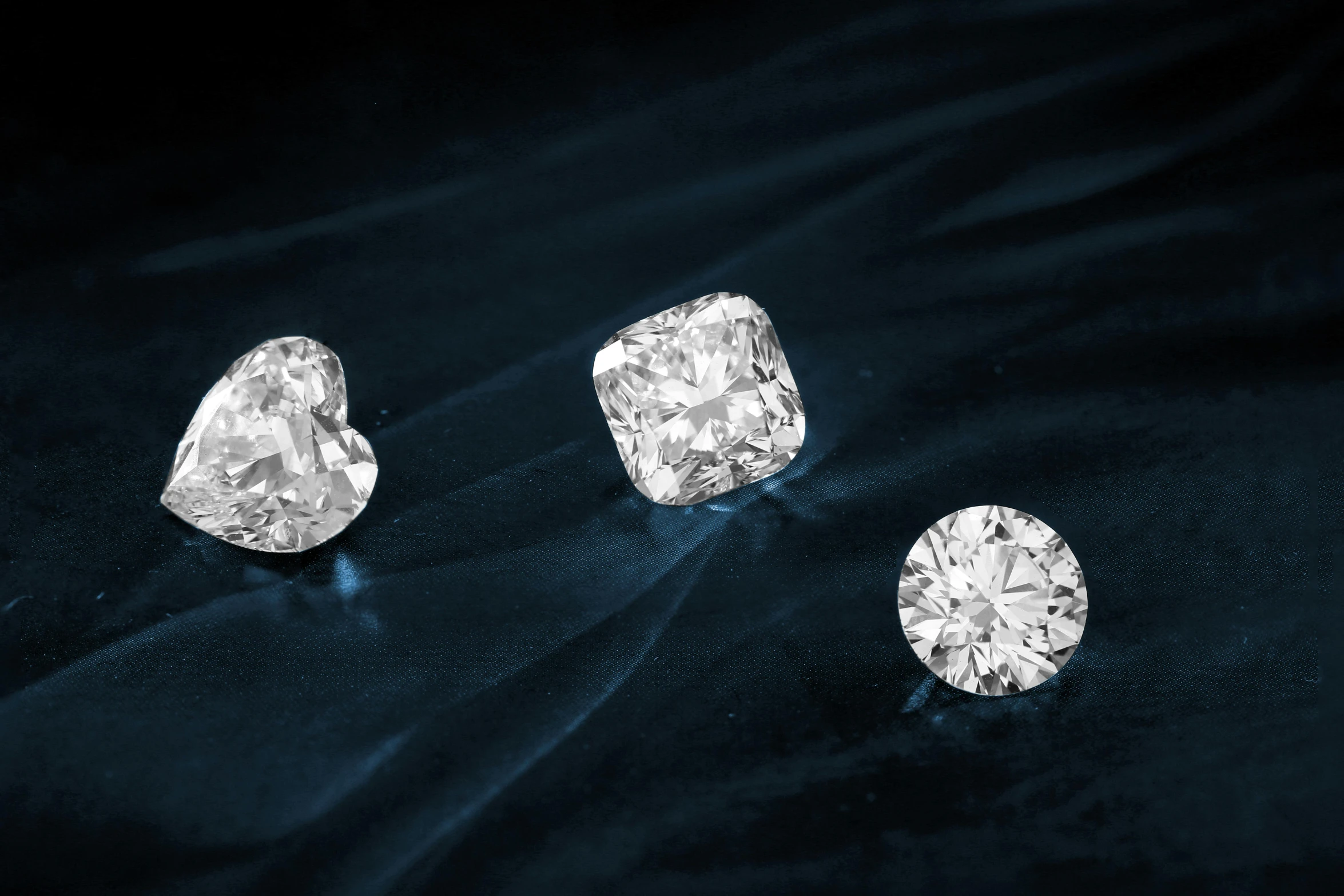 a couple of diamonds sitting on top of a blue cloth, trending on pexels, round corners, featuring rhodium wires, group photo, various sizes