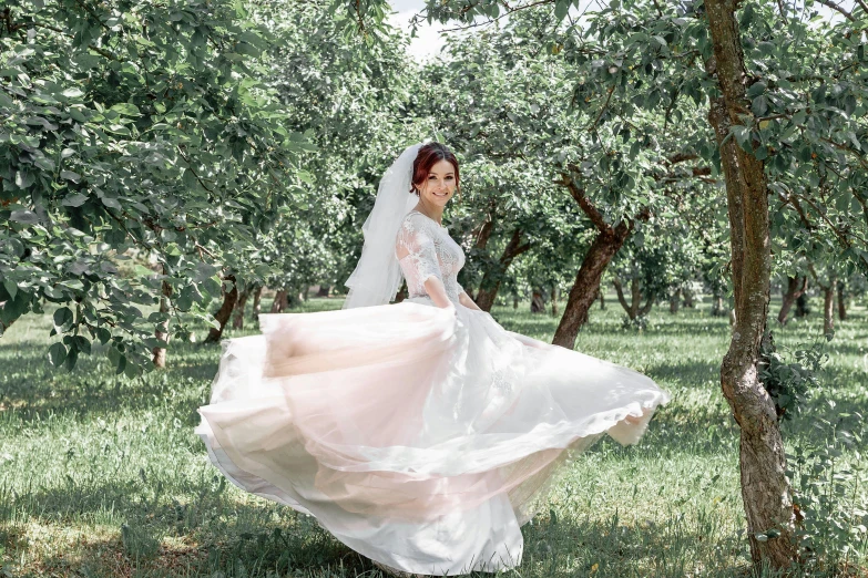 a woman that is standing in the grass, pexels contest winner, arabesque, in wedding dresses, apple trees, wearing organza gown, 15081959 21121991 01012000 4k